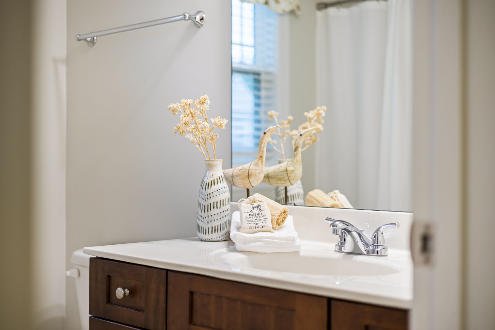 Neatly staged, spotless bathroom vanity and sink
